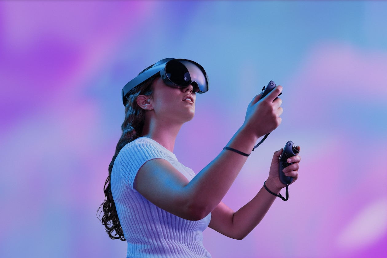 woman wearing oculus headset and holding controllers