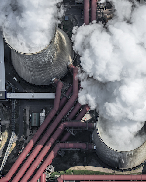 Steam coming out of cooling towers of coal-fired power station, aerial view